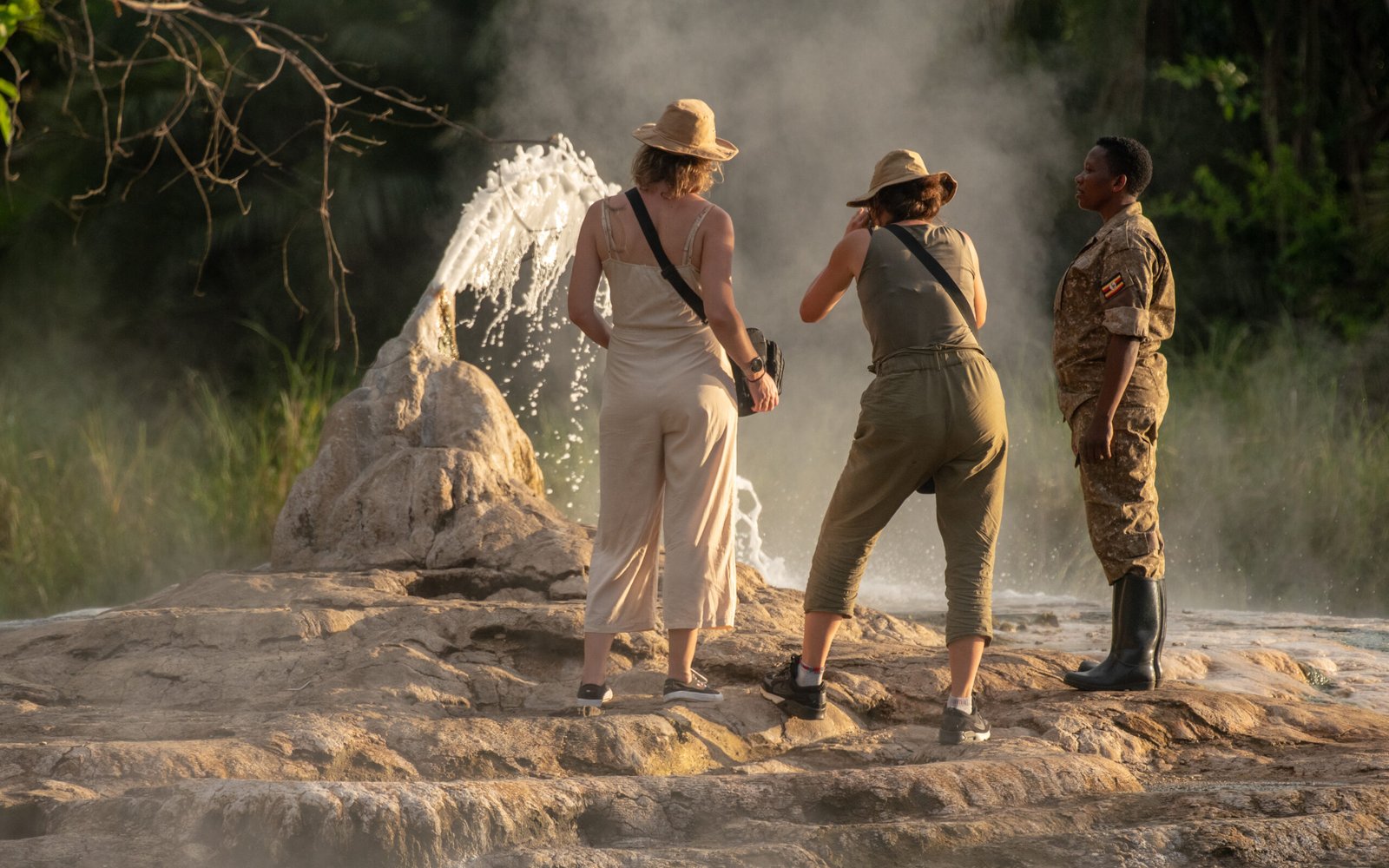 Tourists exploring the hot springs area in Semuliki National Park during a wildlife and nature safari in Uganda.